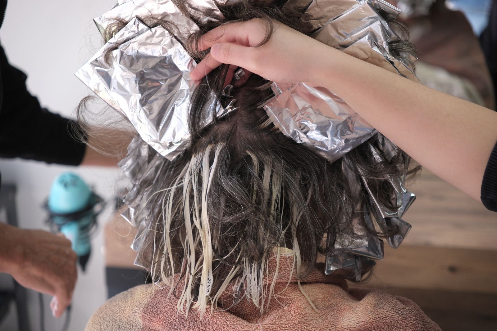 Foil highlights being applied to short hair